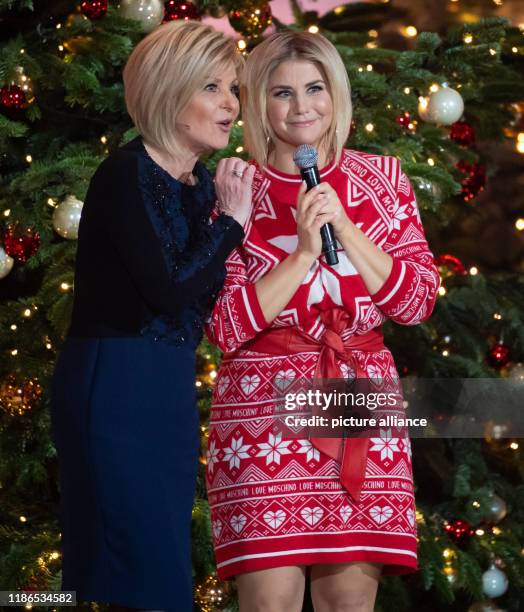 December 2019, Bavaria, Munich: Beatrice Egli , singer, and Carmen Nebel, presenter, at the TV donation gala "The most beautiful Christmas hits". The...