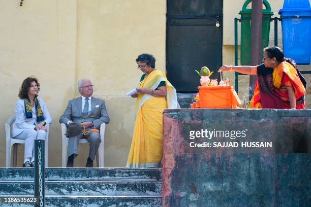 Sweden's King Carl XVI Gustaf and Queen Silvia attend a Ganga Arti Puja, a prayer service, performed by two female priests on the banks of the Ganga...