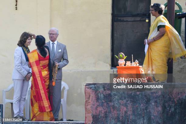 Sweden's King Carl XVI Gustaf and Queen Silvia attend a Ganga Arti Puja, a prayer service, performed by two female priests on the banks of the Ganga...