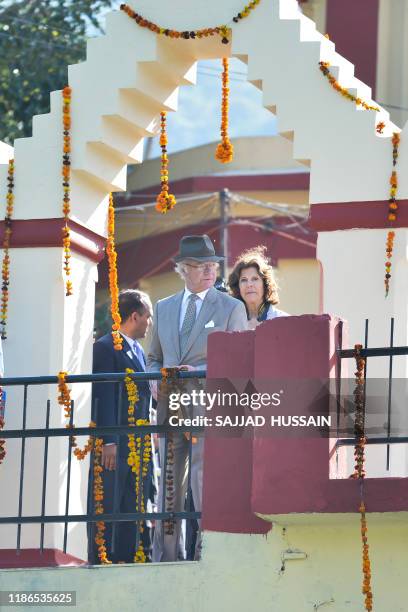 Sweden's King Carl XVI Gustaf and Queen Silvia arrive to attend a Ganga Arti Puja, a prayer service, on the banks of the Ganga river in Rishikesh on...