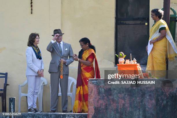 Sweden's King Carl XVI Gustaf and Queen Silvia attend a Ganga Arti Puja, a prayer service, performed by two female priests on the banks of the Ganga...