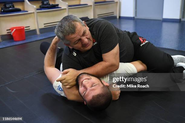 Lightweight champion Khabib Nurmagomedov grapples with his father Abdulmanap Nurmagomedov backstage during the UFC Fight Night event at CSKA Arena on...