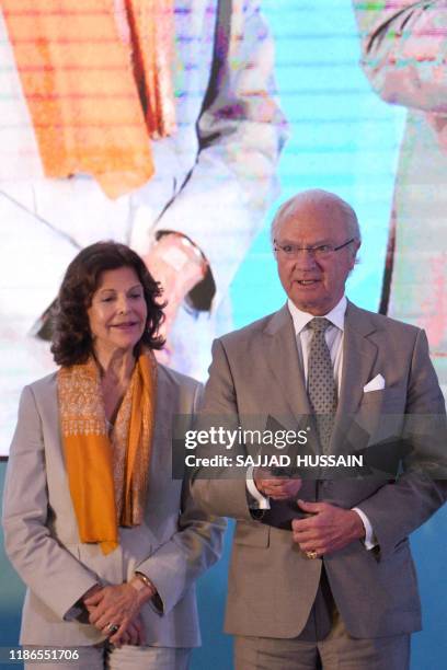 Sweden's King Carl XVI Gustaf inaugurates the Sarai sewage treatment plant as Queen Silvia looks on in Haridwar on December 5, 2019.