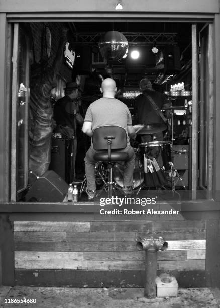 Band plays in front of an open window of a bar in the Lower Broadway entertainment district of Nashville, Tennessee.