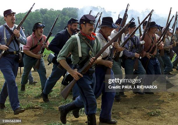 Infantry soldiers of the Union army charge the battlefield at the First Manassas Civil War Reenactment 04 August 2001 in Leesburg, Virginia....