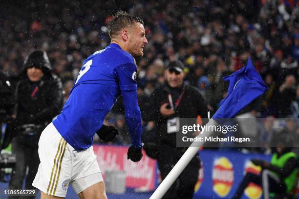 Jamie Vardy of Leicester City punches the corner flag as he celebrates after scoring his team's first goal during the Premier League match between...