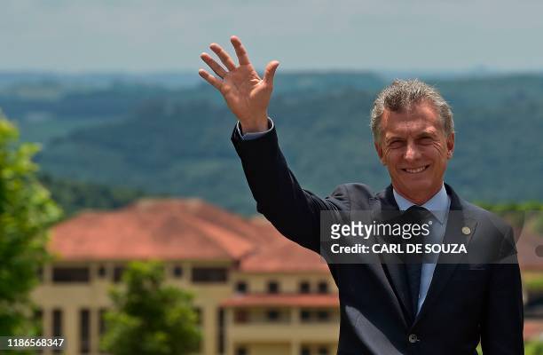Argentina's President Mauricio Macri waves during the family picture of the 55th Mercosur summit in Bento Goncalves, Rio Grande do Sul, Brazil, on...