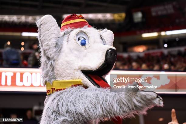 Calgary Flames mascot Harvey the Hound gestures to a fan during the third period of an NHL game where the Calgary Flames hosted the Ottawa Senators...