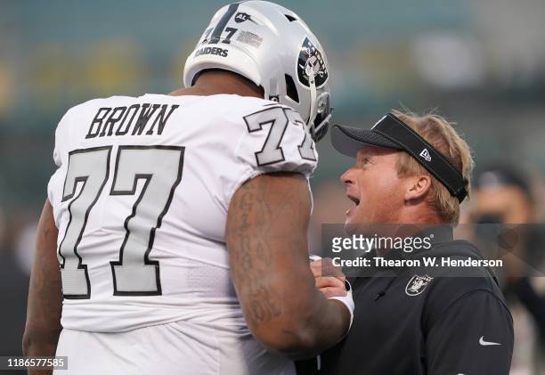 Head coach Jon Gruden of the Oakland Raiders talks with his player Forrest Lamp during pregame warm ups prior to the start of an NFL football game...
