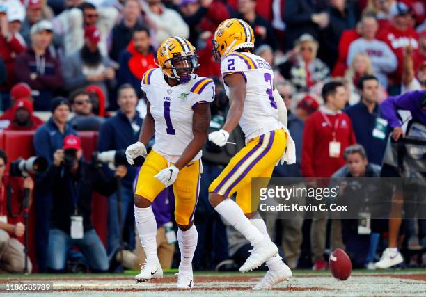 Ja'Marr Chase of the LSU Tigers celebrates with Justin Jefferson after scoring a 33-yard receiving touchdown during the first quarter against the...