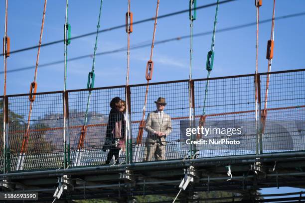 Sweden's King Carl XVI Gustaf and Queen Silvia walk on the Ram Jhula bridge over Ganga river in Rishikesh, Uttarakhand, India on 5 December 2019.