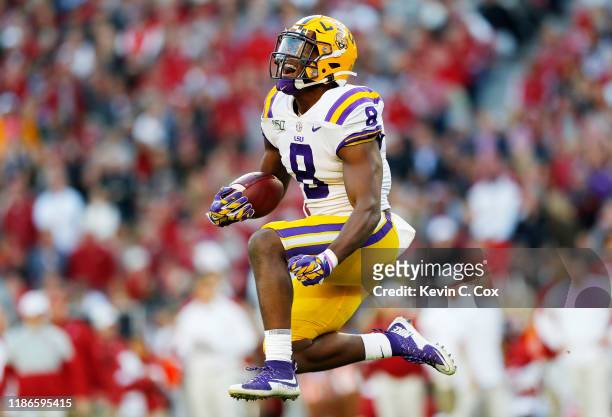 Patrick Queen of the LSU Tigers celebrates after intercepting a pass during the second quarter against the Alabama Crimson Tide in the game at...