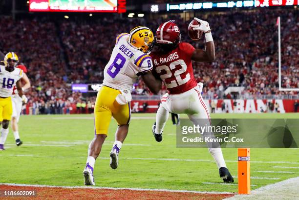 Najee Harris of the Alabama Crimson Tide catches a 15-yard touchdown pass as he is defended by Patrick Queen of the LSU Tigers during the third...