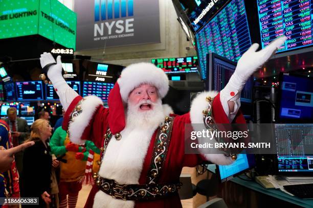 Santa Claus gestures on the floor at the closing bell of the Dow Industrial Average at the New York Stock Exchange on December 5, 2019 in New York. -...