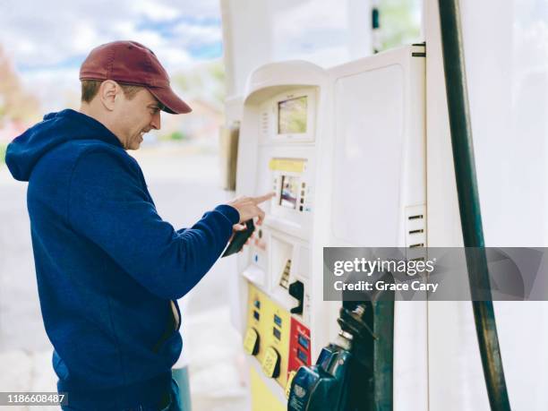 close-up of man purchasing gas at station - petrol paying ストックフォトと画像