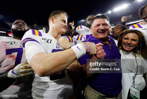 Joe Burrow of the LSU Tigers celebrates with head coach Ed Orgeron after defeating the Alabama Crimson Tide 46-41 at Bryant-Denny Stadium on November...