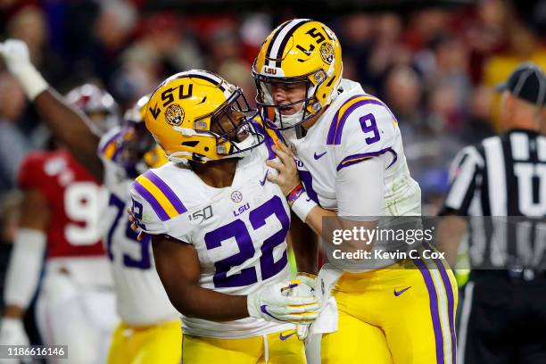 Joe Burrow celebrates with Clyde Edwards-Helaire of the LSU Tigers during the second half against the Alabama Crimson Tide in the game at...