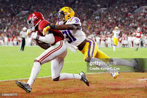 Jerry Jeudy of the Alabama Crimson Tide catches a touchdown pass against Cameron Lewis of the LSU Tigers during the fourth quarter in the game at...