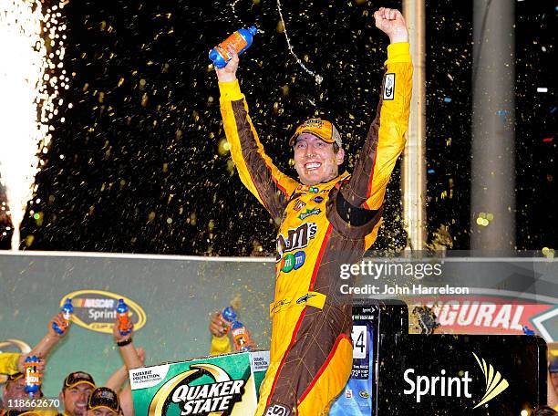 Kyle Busch, driver of the M&M's Toyota, celebrates in Victory Lane after winning the NASCAR Sprint Cup Series Quaker State 400 at Kentucky Speedway...