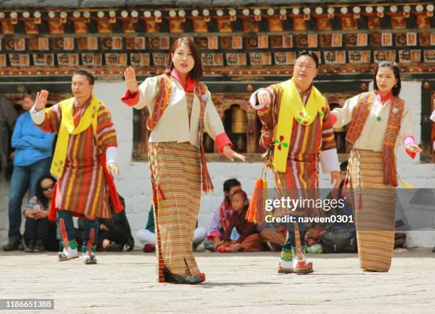 bhutanese people dancing in traditional dress - thimphu bhutan stock pictures, royalty-free photos & images