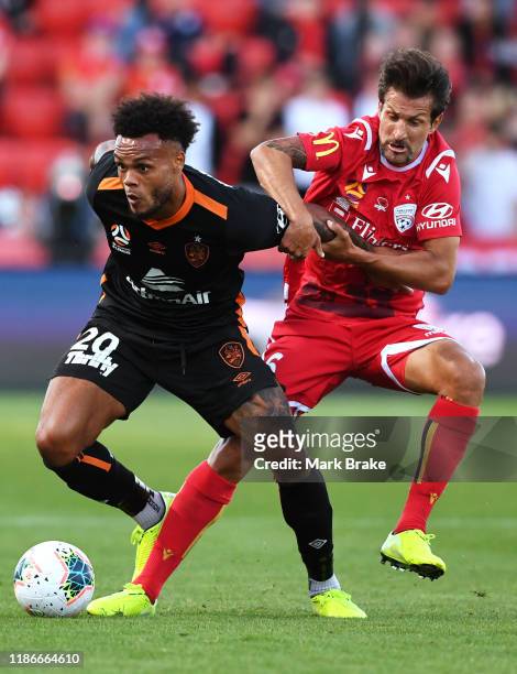 Aaron Amadi-Holloway of the Brisbane Roar competes with Vince Lia of Adelaide United during the Round 5 A-League match between Adelaide United and...