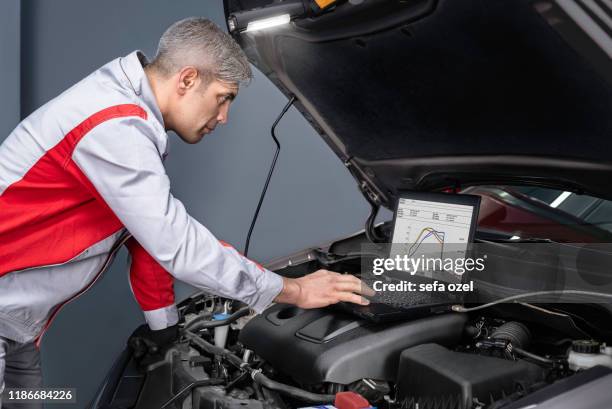 auto mechanic computer problems searching  the engine in the car - luxury cars stock pictures, royalty-free photos & images