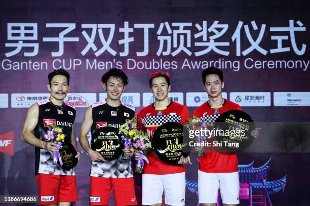 Keigo Sonoda and Takeshi Kamura of Japan and Marcus Fernaldi Gideon and Kevin Sanjaya Sukamuljo of Indonesia pose with their trophies after the Men's...