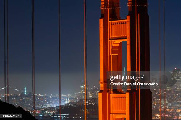 golden gate bridge with transamerica pyramid at night - golden gate bridge city fog stock pictures, royalty-free photos & images