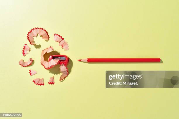 red crayon pencil and shavings - sharpening stock pictures, royalty-free photos & images