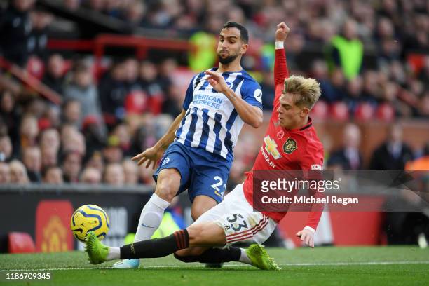Brandon Williams of Manchester United tackles Martin Montoya of Brighton and Hove Albion during the Premier League match between Manchester United...