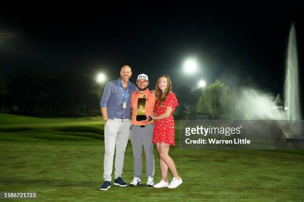 Tyrrell Hatton of England poses with his manager and girlfriend Emily Braisher after winning the 2019 Turkish Airlines Open in a playoff on Day Four...