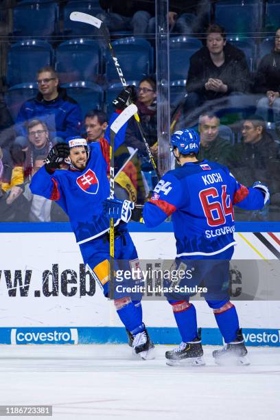 Peter Zuzin of Slovakia celebrates his team's winning goal in overtime with Patrik Koch of Slovakia during the Deutschland Cup 2019 match between...