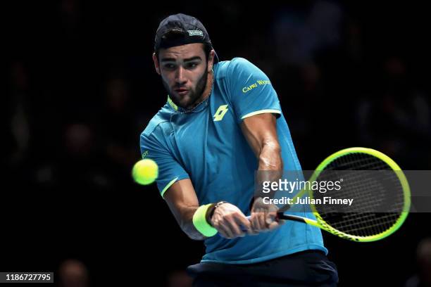 Matteo Berrettini of Italy plays a backhand in his singles match against Novak Djokovic of Serbia during Day One of the Nitto ATP Finals at The O2...