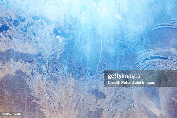 defocused blue background with ice flowers - blue glass stock pictures, royalty-free photos & images