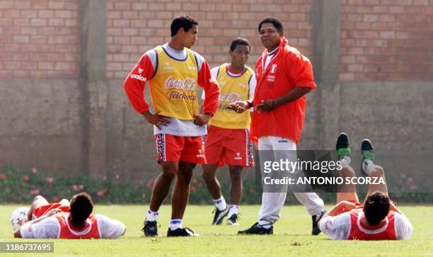 Coach of the Peruvian team Francisco Maturano gives instructions to players Johnny Vegas and Juan Jayo 02 June 2000. El director tecnico del...