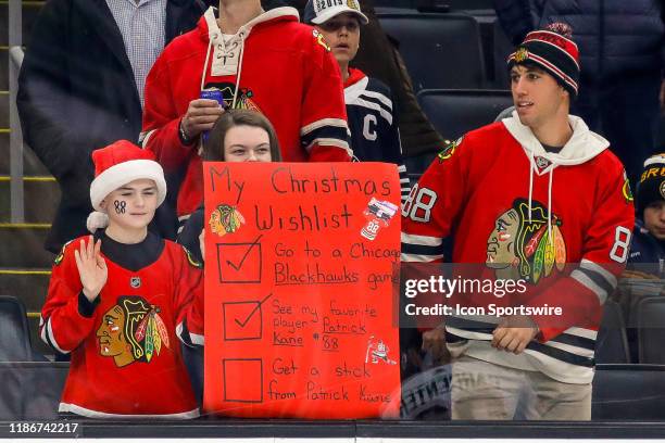 Fans of Chicago Blackhawks right wing Patrick Kane display a request during warmups prior to the Chicago Blackhawks and Boston Bruins NHL game on...