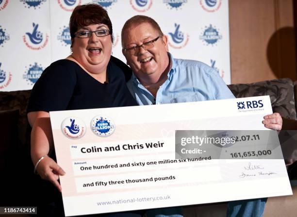 Colin Weir and his wife Chris pose for pictures during a photocall in Falkirk, Scotland, on July 15 after winning a record GBP161m in the...