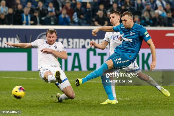 Artem Dzyuba of FC Zenit Saint Petersburg shoots on goal as Vladimir Rykov and Grigori Morozov of FC Dynamo Moscow defend during the Russian Premier...