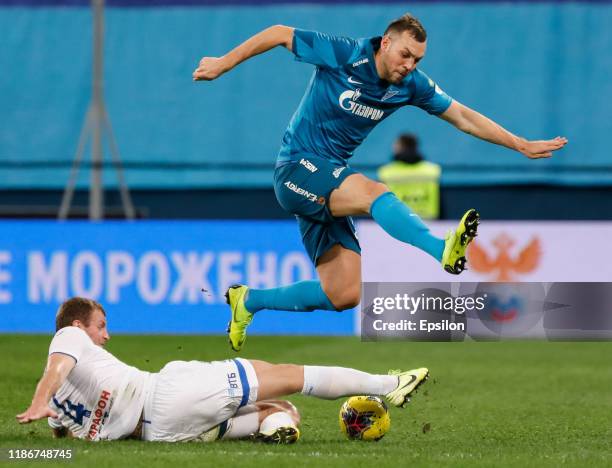 Artem Dzyuba of FC Zenit Saint Petersburg and Vladimir Rykov of FC Dynamo Moscow vie for the ball during the Russian Premier League match between FC...