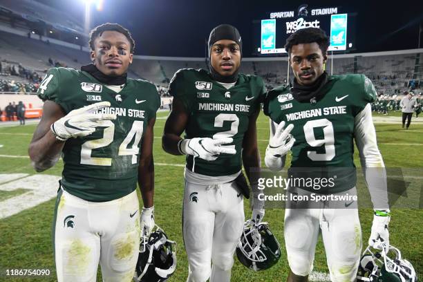 Michigan State running backs Elijah Collins , Anthony Williams Jr. And wide receiver Julian Barnett pose for a picture following a college football...