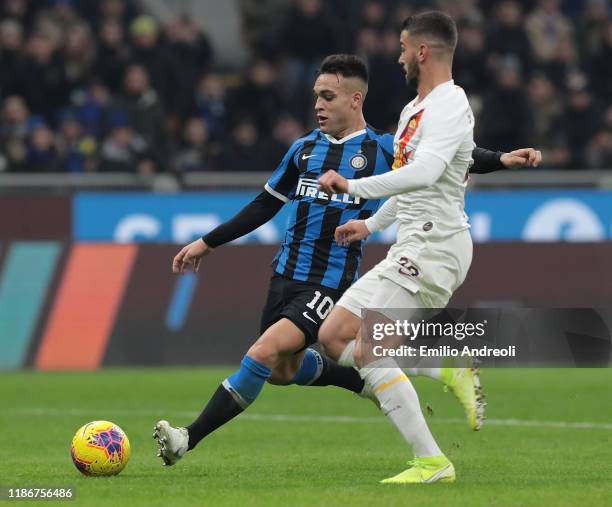 Lautaro Martinez of FC Internazionale is challenged by Leonardo Spinazzola of AS Roma during the Serie A match between FC Internazionale and AS Roma...
