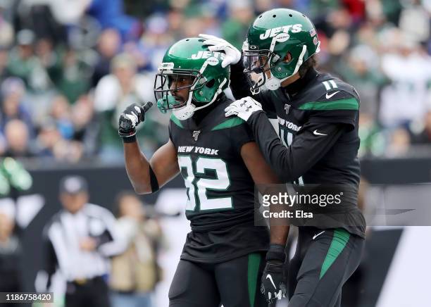 Jamison Crowder of the New York Jets is congratulates by teammate Robby Anderson after Crowder scored a touchdown in the first quarter against the...
