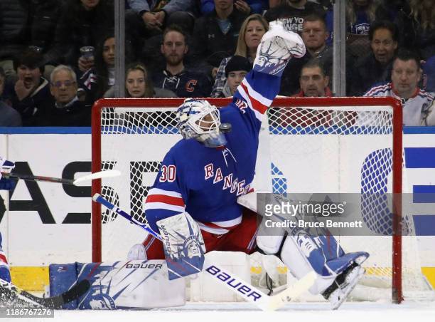 Henrik Lundqvist of the New York Rangers makes a mask save against the Florida Panthers at Madison Square Garden on November 10, 2019 in New York...