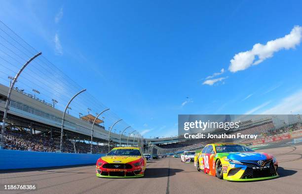 Kyle Busch, driver of the M&M's Toyota, leads the field to the green flag at the satrt of the Monster Energy NASCAR Cup Series Bluegreen Vacations...