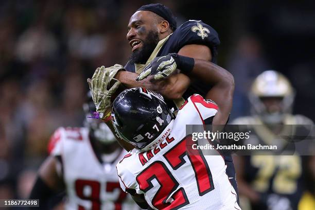 Tre'Quan Smith of the New Orleans Saints catches the ball as Damontae Kazee of the Atlanta Falcons defends during the second half of a game at the...