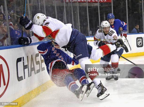 Brian Boyle of the Florida Panthers checks Ryan Lindgren of the New York Rangers into the boards during the third period at Madison Square Garden on...
