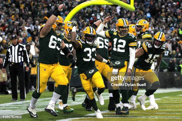 Aaron Jones of the Green Bay Packers celebrates with his teammates after scoring a 5 yard touchdown against the Carolina Panthers during the first...