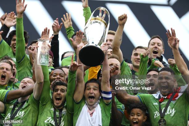 Nicolas Lodeiro of the Seattle Sounders FC holds the trophy and celebrates with his teammates after winning the MLS Cup 2019 against the Toronto FC...