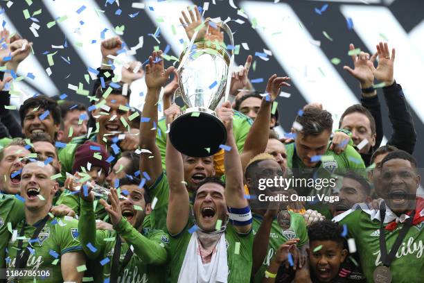 Nicolas Lodeiro of the Seattle Sounders FC holds the trophy and celebrates with his teammates after winning the MLS Cup 2019 against the Toronto FC...