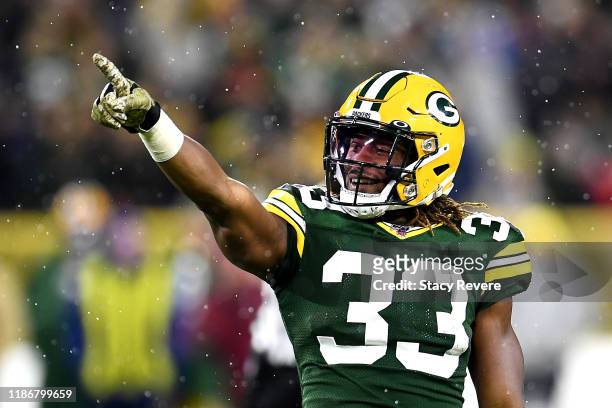 Aaron Jones of the Green Bay Packers celebrates a first down against the Carolina Panthers during the third quarter in the game at Lambeau Field on...